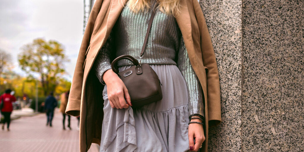 A female model carries a purse across her body